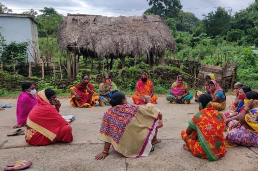 Women gathered in a self-help group meeting in Odisha, India, reflecting mental health awareness, community listening, and emotional support.